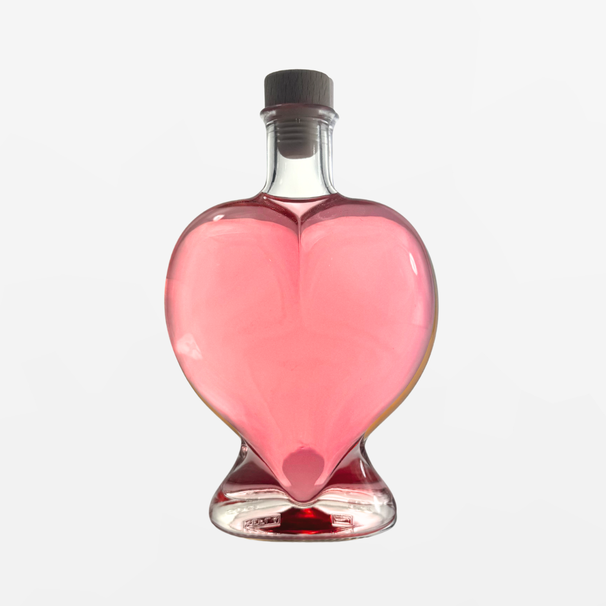 Flaschengeist Heart Birthday Gift — romantic handcrafted glass heart bottle filled with premium spirits, front-facing hero shot on cream background