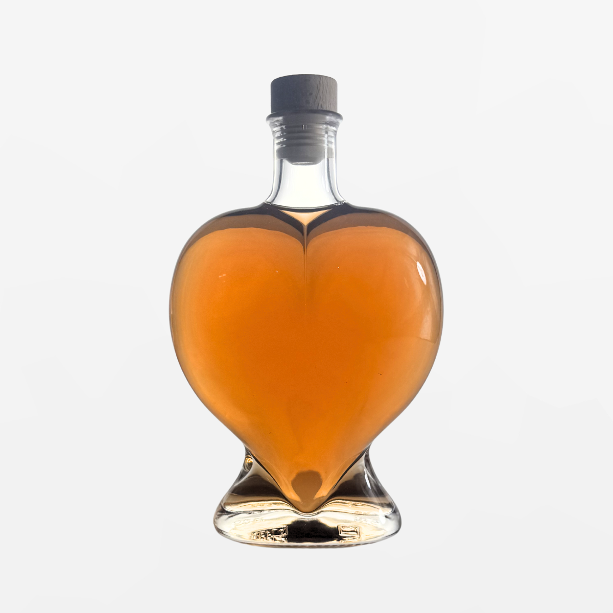 Flaschengeist Heart Birthday Gift — romantic handcrafted glass heart bottle filled with premium spirits, front-facing hero shot on cream background